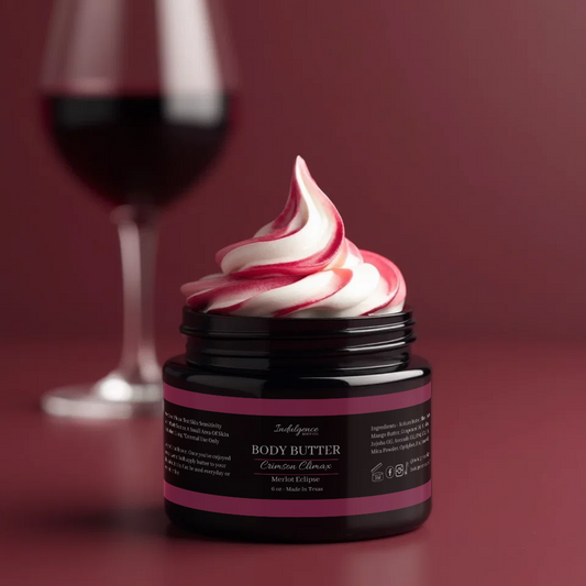 Jar of body butter with pink and white swirl on a red background with a glass of red wine.
